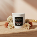 Black Flamez Baja Bloom candle in a warm desert-luxury setting with soft florals and sand