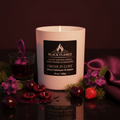 Drunk in Love Black Flamez candle surrounded by crushed cherries, heliotrope, fir balsam, wild strawberry, sandalwood, and cognac tones